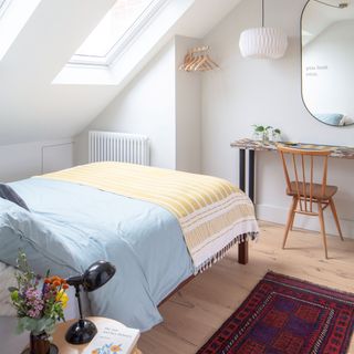 Loft conversion white guest room with single bed and desk