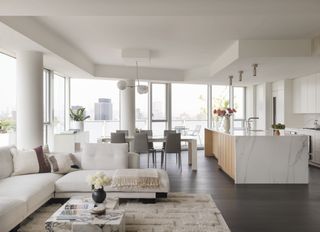 white minimalist open space with living, dining and kitchen
