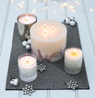 room with white candles on rugs