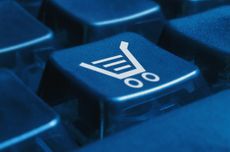 Consumer spending shown by shopping card icon on blue keyboard