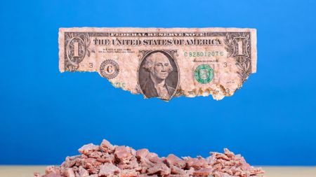 a dollar bill crumbling indicating eroding purchasing power