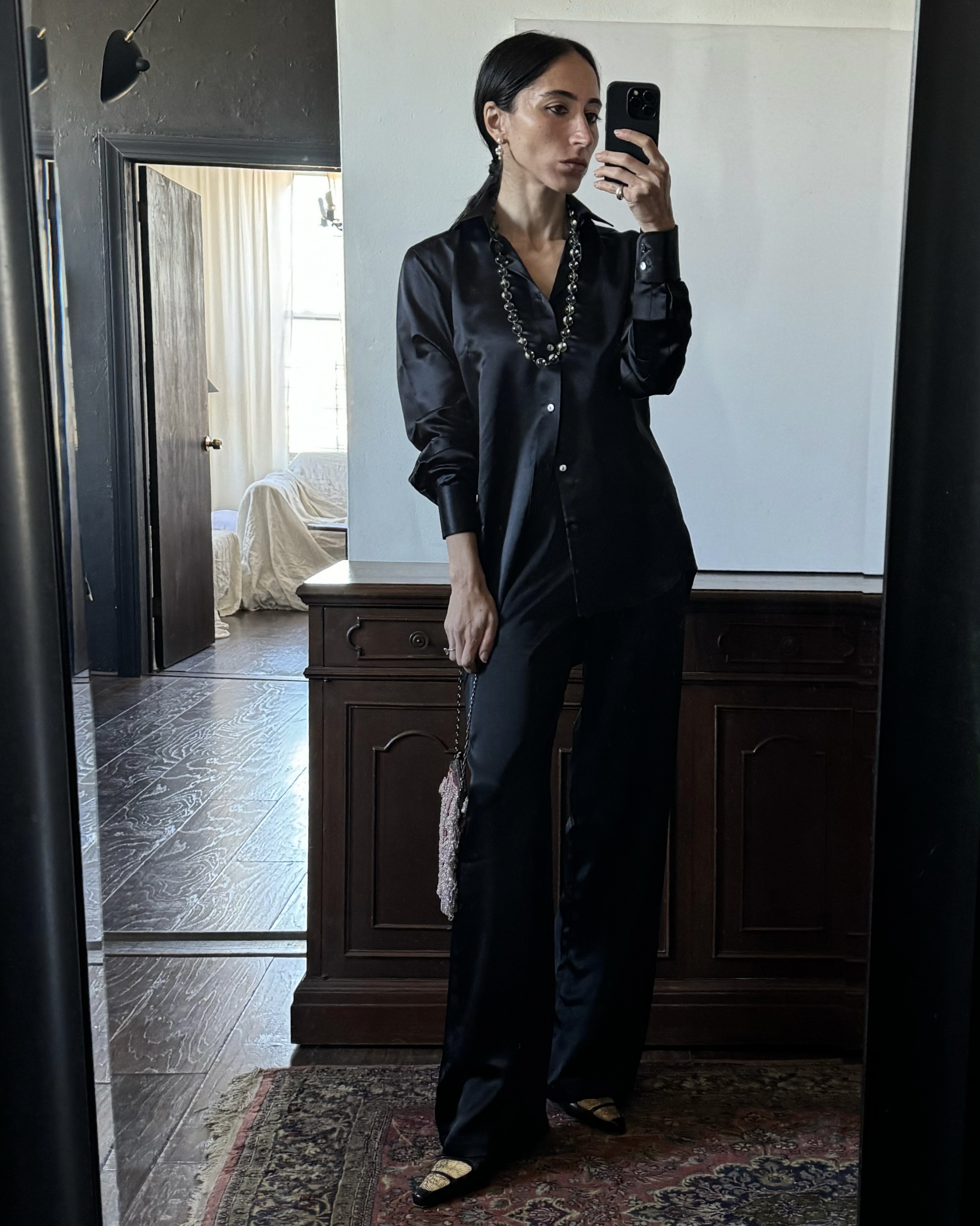 Alexis Badiyi wearing black silk pajamas