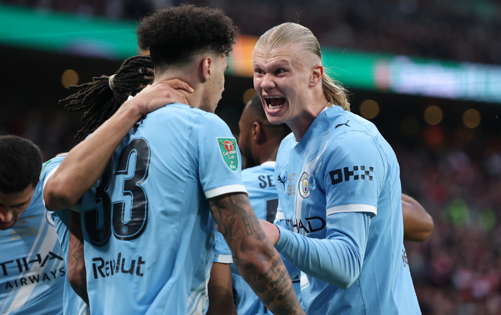  Nico O'Reilly of Manchester City celebrates scoring his team's first goal with Erling Haaland during the Carabao Cup Final match between Arsenal and Manchester City at Wembley Stadium on March 22, 2026
