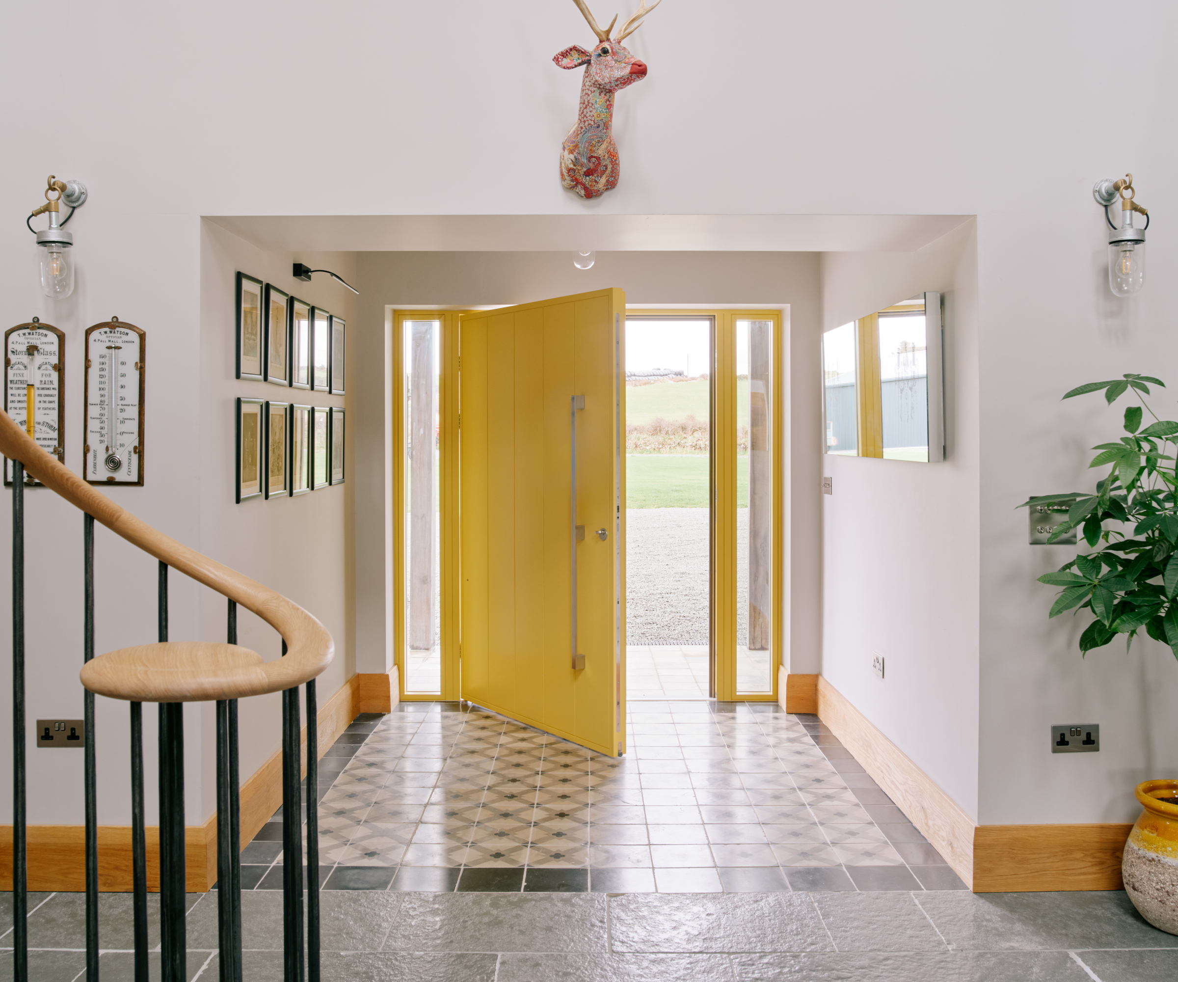 large modern yellow front door viewed from inside hallway