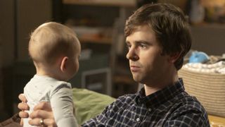 Freddie Highmore as Shaun holding a baby in The Good Doctor season 7