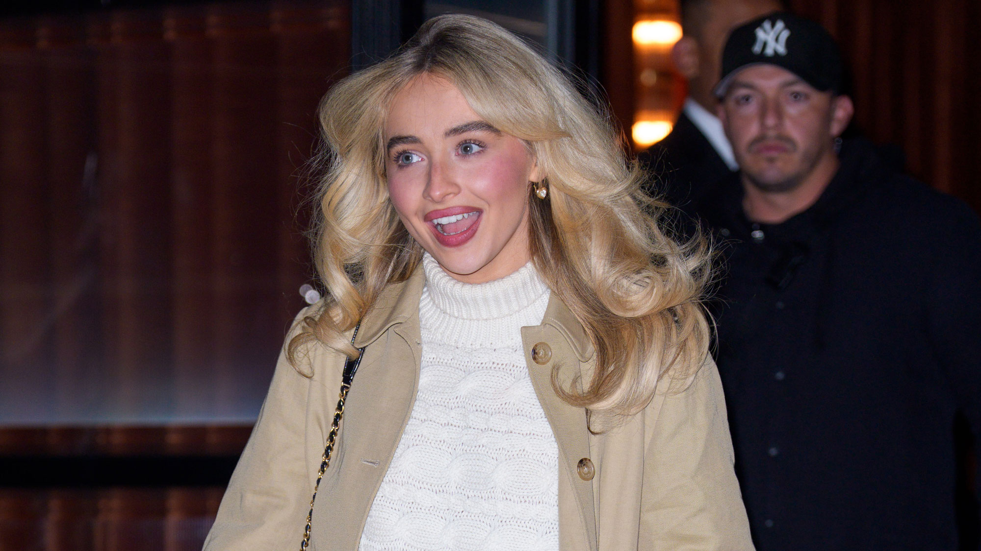 Sabrina Carpenter wears a white turtleneck sweater.