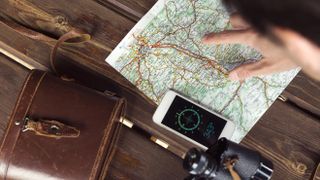 Map with a smartphone and binoculars