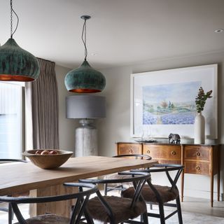 dining room with patinated lampshades above wooden table