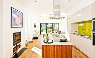 narrow kitchen extension completed under permitted development with wooden kitchen island