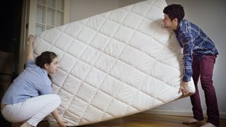 Man and woman rotate their double mattress