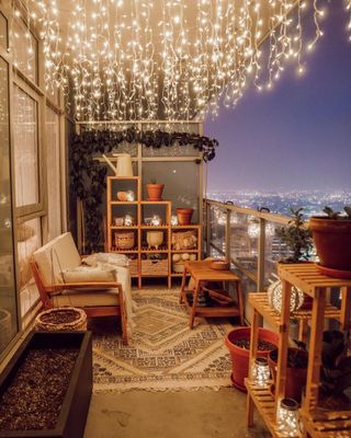 Outdoor balcony with string lights at night