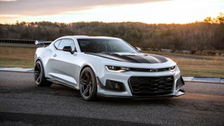 A white 2019 Chevrolet Camaro ZL1 with black hood, on a race track