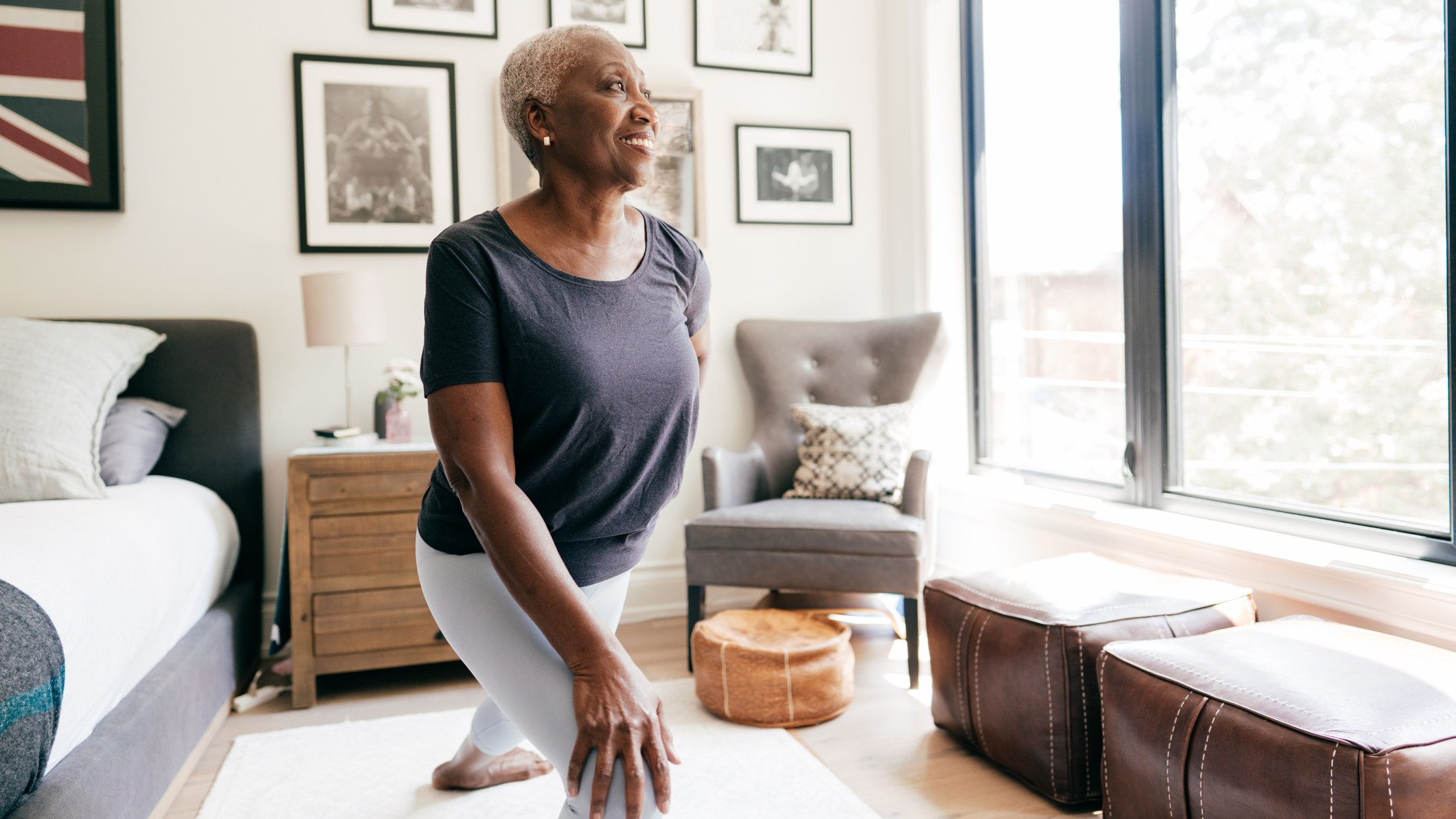 Woman stretching her legs in a bedroom