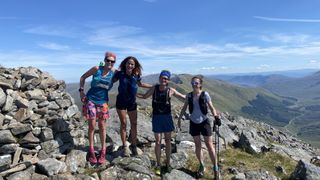 four runners in scottish mountains