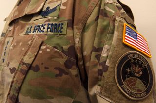 Traditional camouflage uniform adorned with a blue "U.S. Space Force" nameplate.