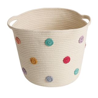 white wonven basket with colourful polka dots