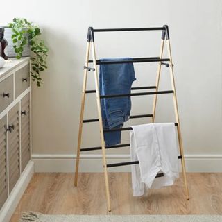 Wooden triangular drying rack with clothes 