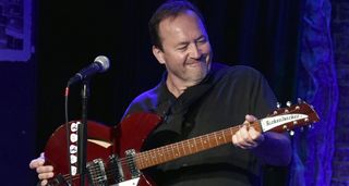 Jim Babjak of the Smithereens smiles has he holds his deep red Rickenbacker onstage
