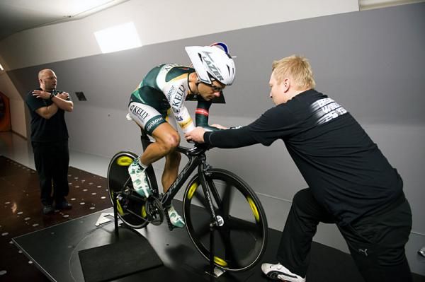 A2 Wind Tunnel's Mike Giraud, left, and aero consultant Chris Edin, right, work with Neil Shirley's arm position.