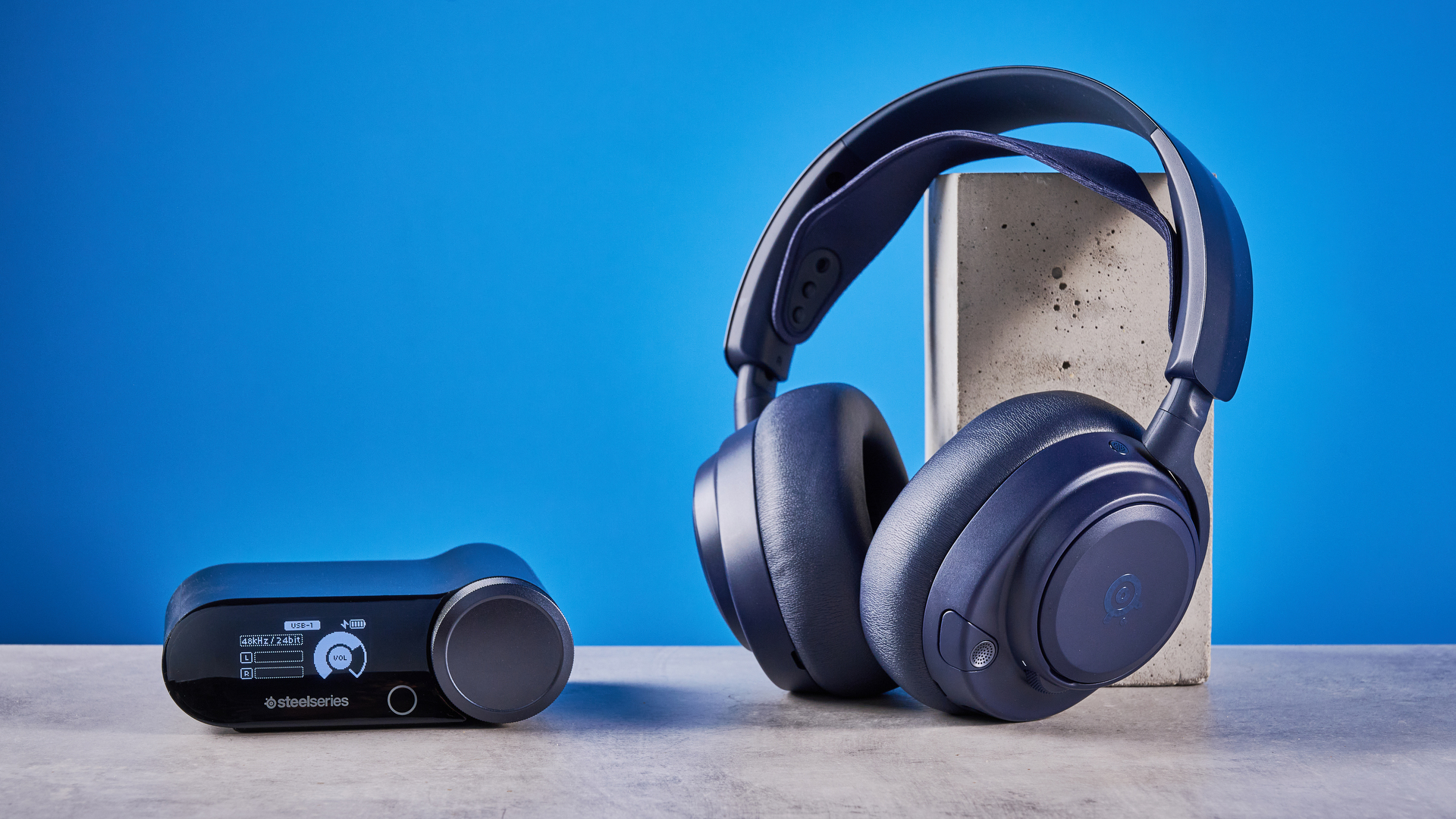 The SteelSeries Arctis Nova Pro Omni on a stone surface against a blue background