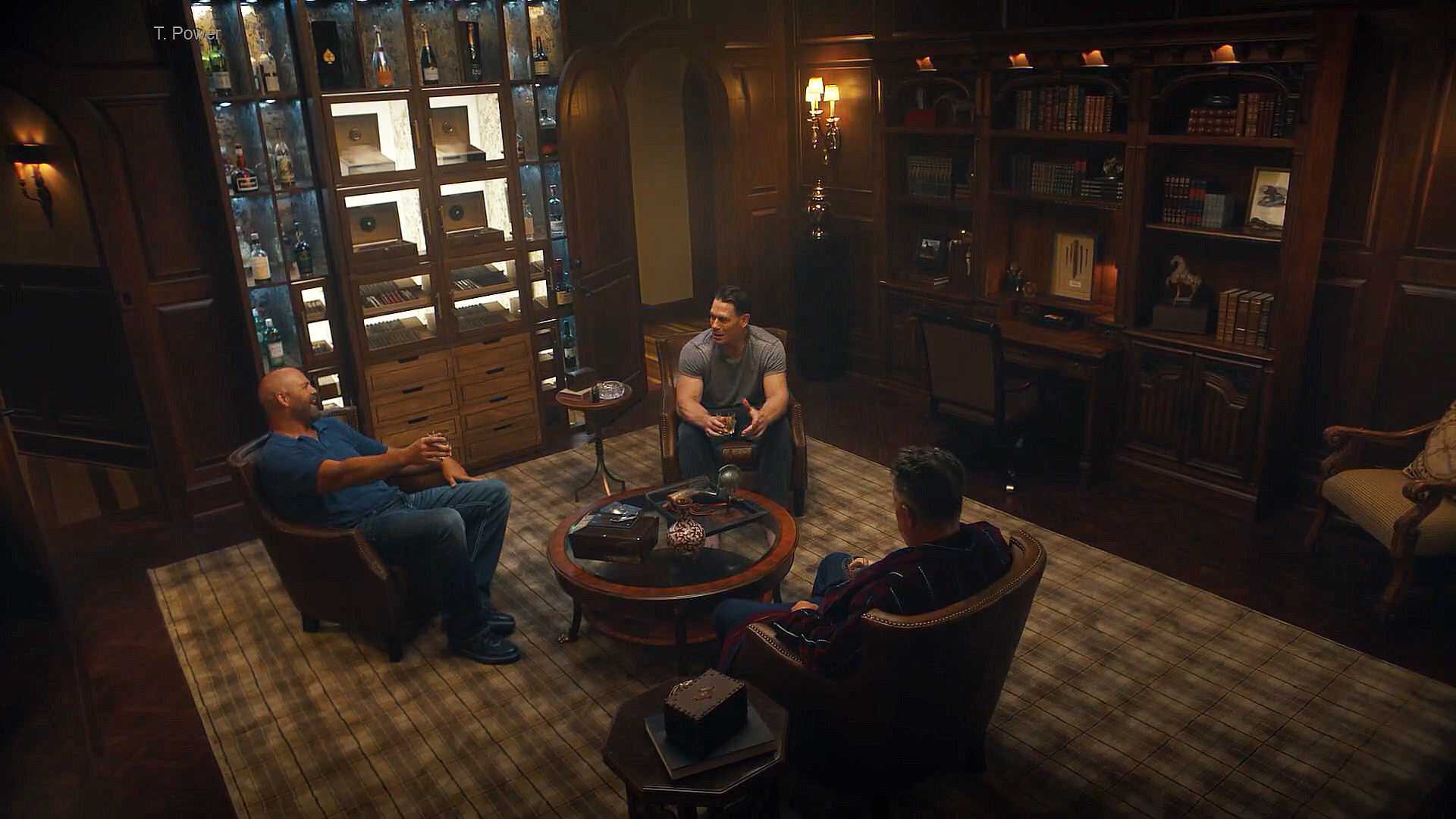 A wide shot of Keith, Chris, and Auggie sharing a drink in a lounge in Peacemaker season 2 episode 1