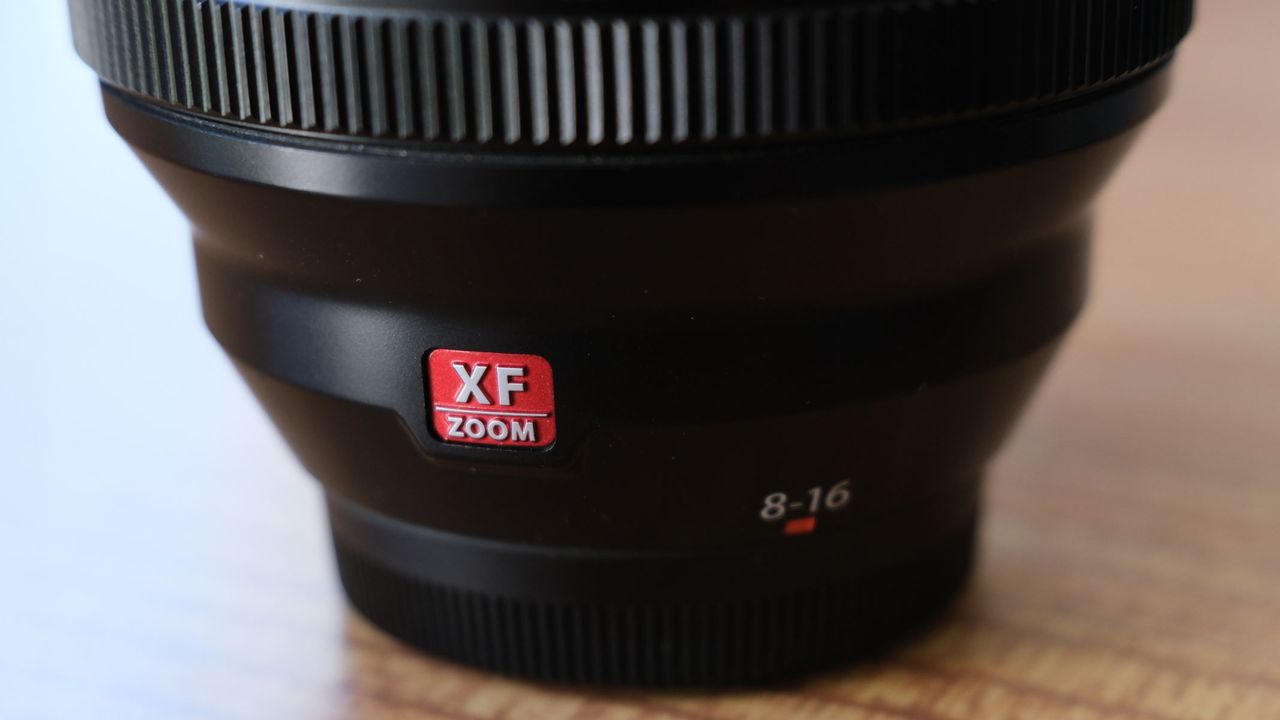 A close-up of the Fujifilm XF 8-16mm f/2.8 lens showing the red XF zoom logo