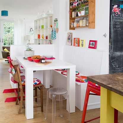 quirky dining area with white table and wooden chairs