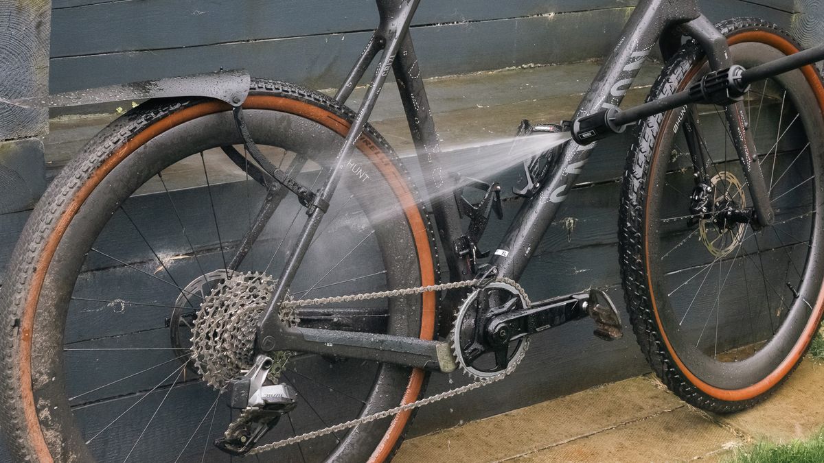 Close-up view of Muc-Off Mobile Bike Pressure lance spraying on a Canyon bike