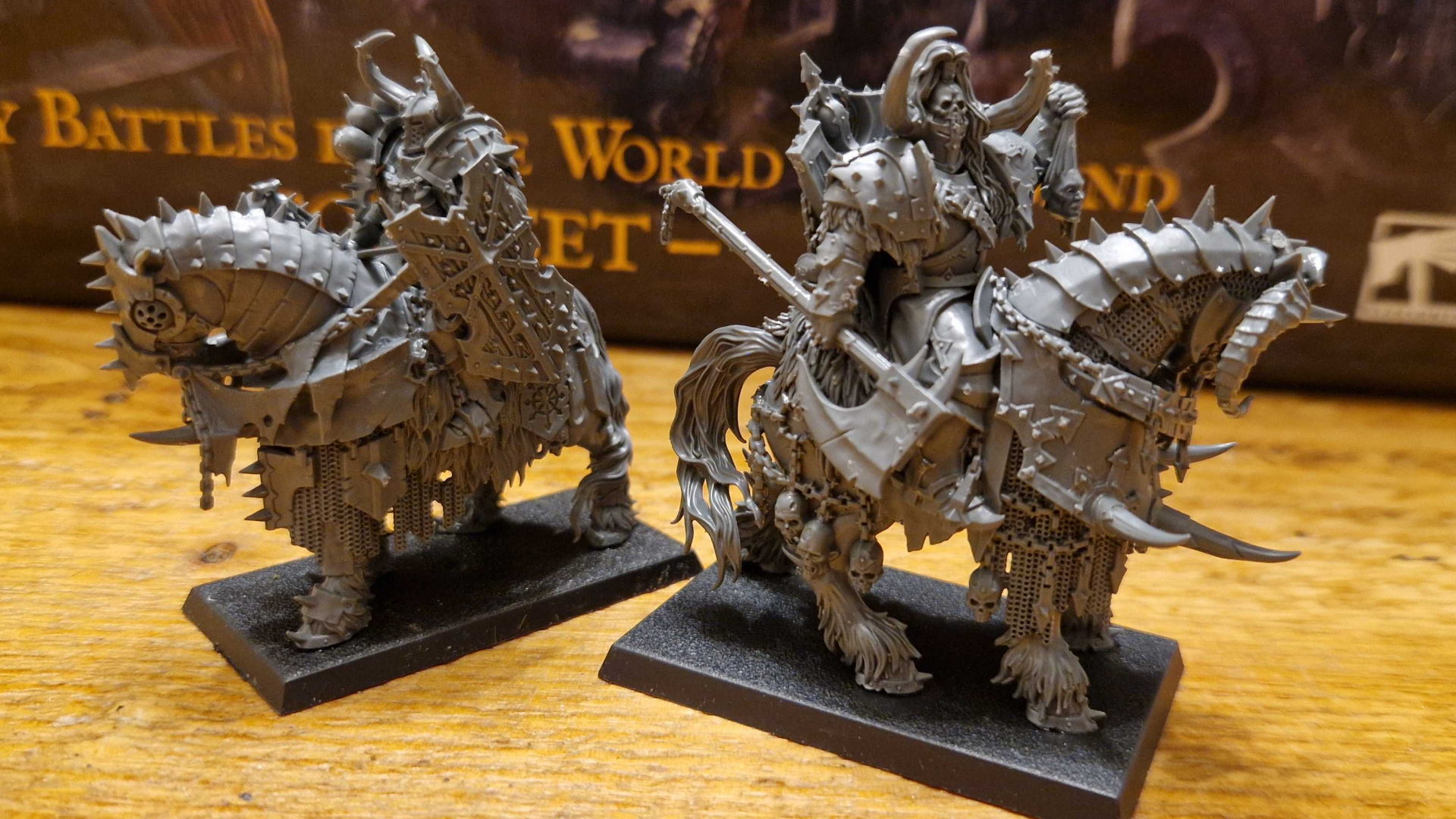 Warhammer The Old World Chaos Warriors models on a wooden table