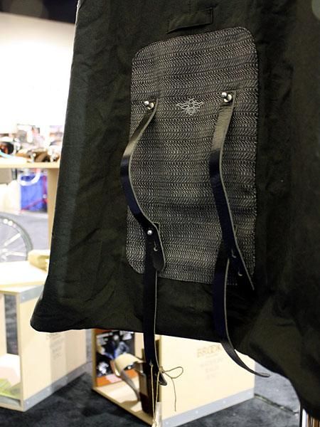 The Brooks Oxford rain cape rolls up and secures beneath the saddle with the built-in straps.