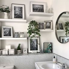 bathroom with white wall frames and mirror on wall