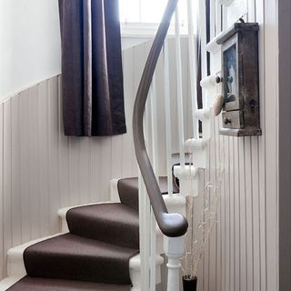 stairway with carpeted staircase and curtain on window