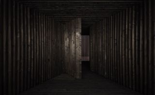 Empty space with dark wooden walls, floor and ceiling