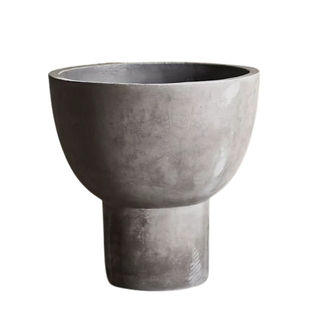 A footed concrete bowl planter