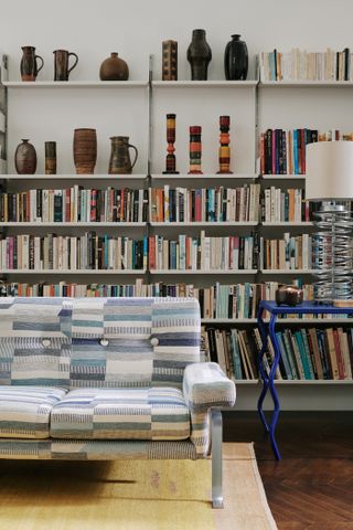 A living room with an accent wall of books