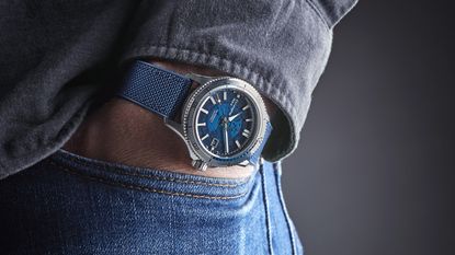 A man wearing one of the best watches under £1000, with his hand in his pocket showing off the watch