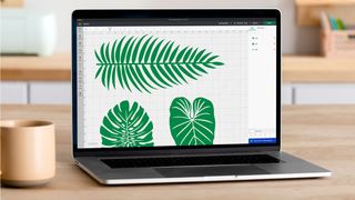 How to use a Cricut; a laptop with the design of a leaf on the screen
