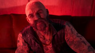 Silky, a bald vampire with lots of tattoos and a long mustache, from Bloodlines 2