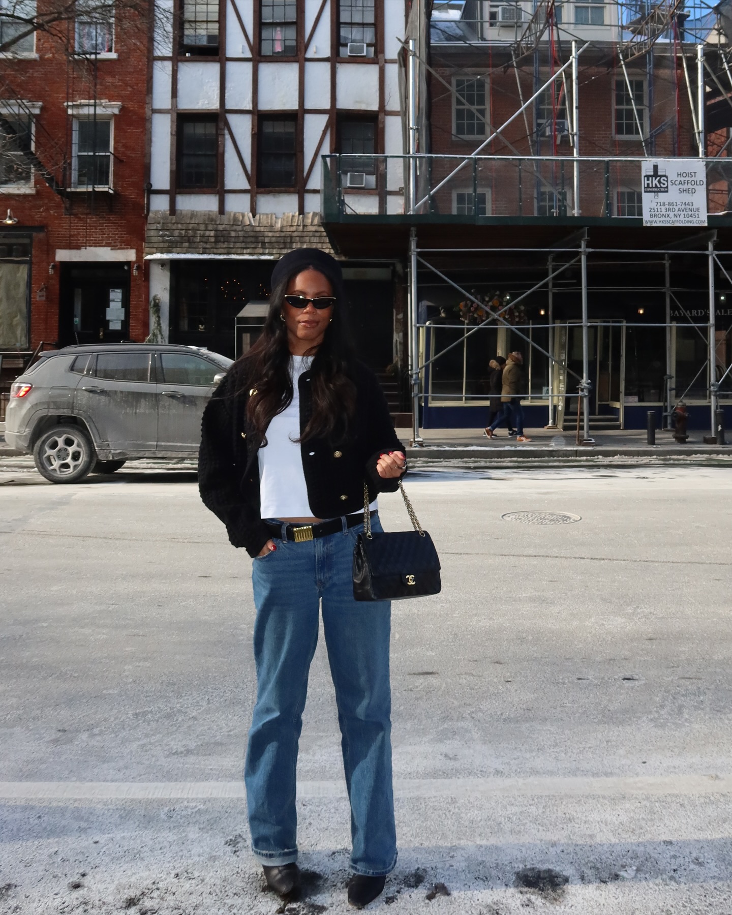 Sierra wears a black hat, white tee, black jacket, chanel bag, and abercrombie low-rise baggy jeans.