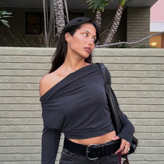 woman wearing black off the shoulder top and light black jeans