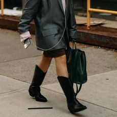 fashion week spring 2026 attendee wearing black cowboy boots