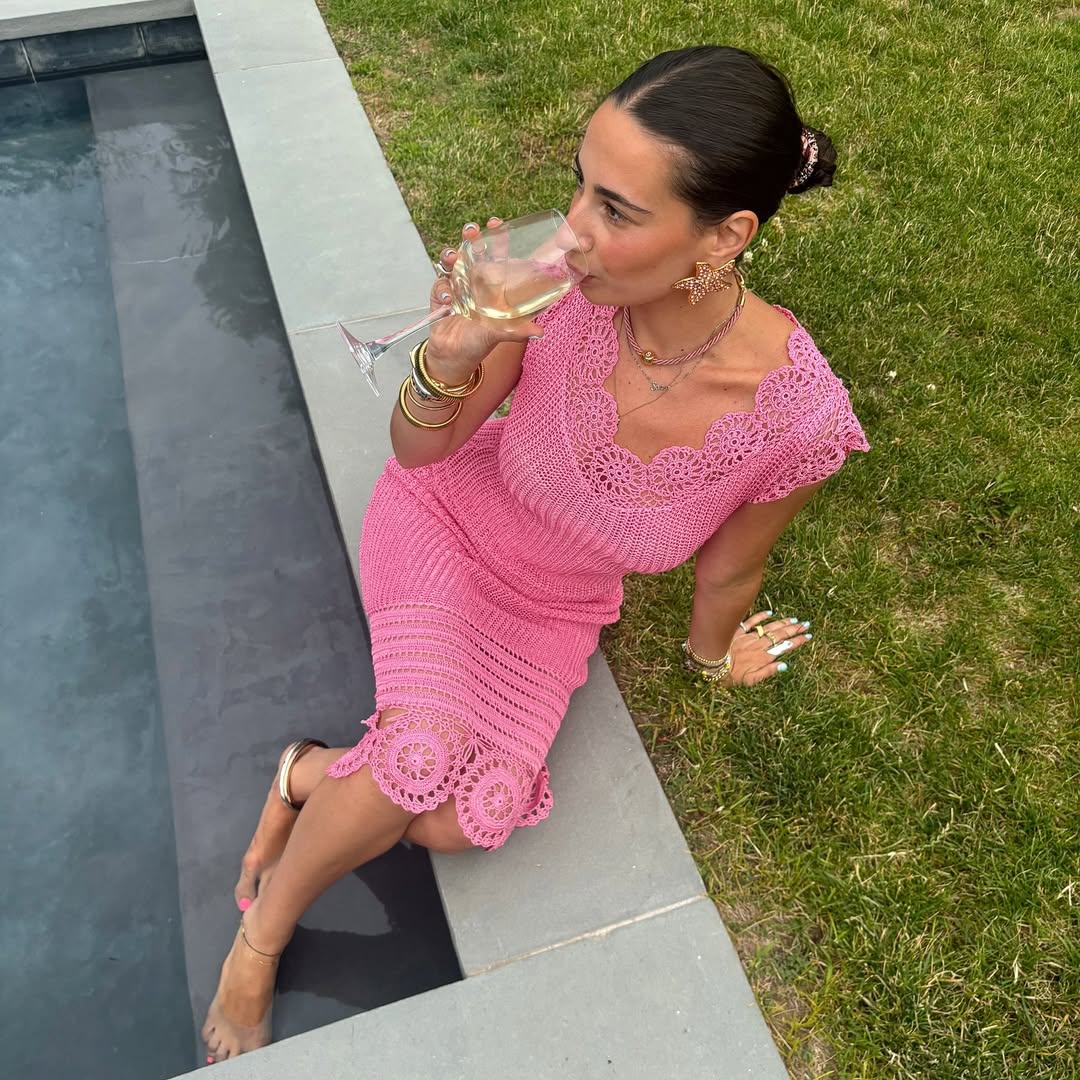 An influencer wearing a pink dress.