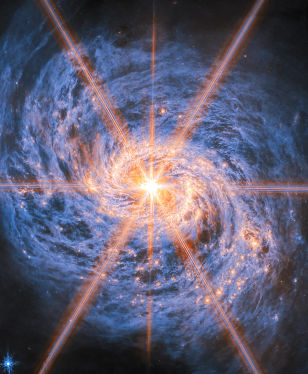 an eight-pointed star of bright red and white light on a purple swirl of gas