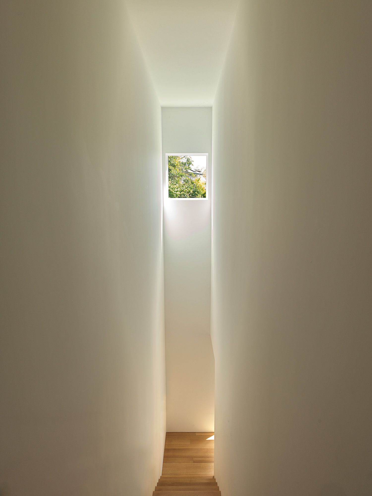 A narrow stairwell leads up to the principal bedroom suite