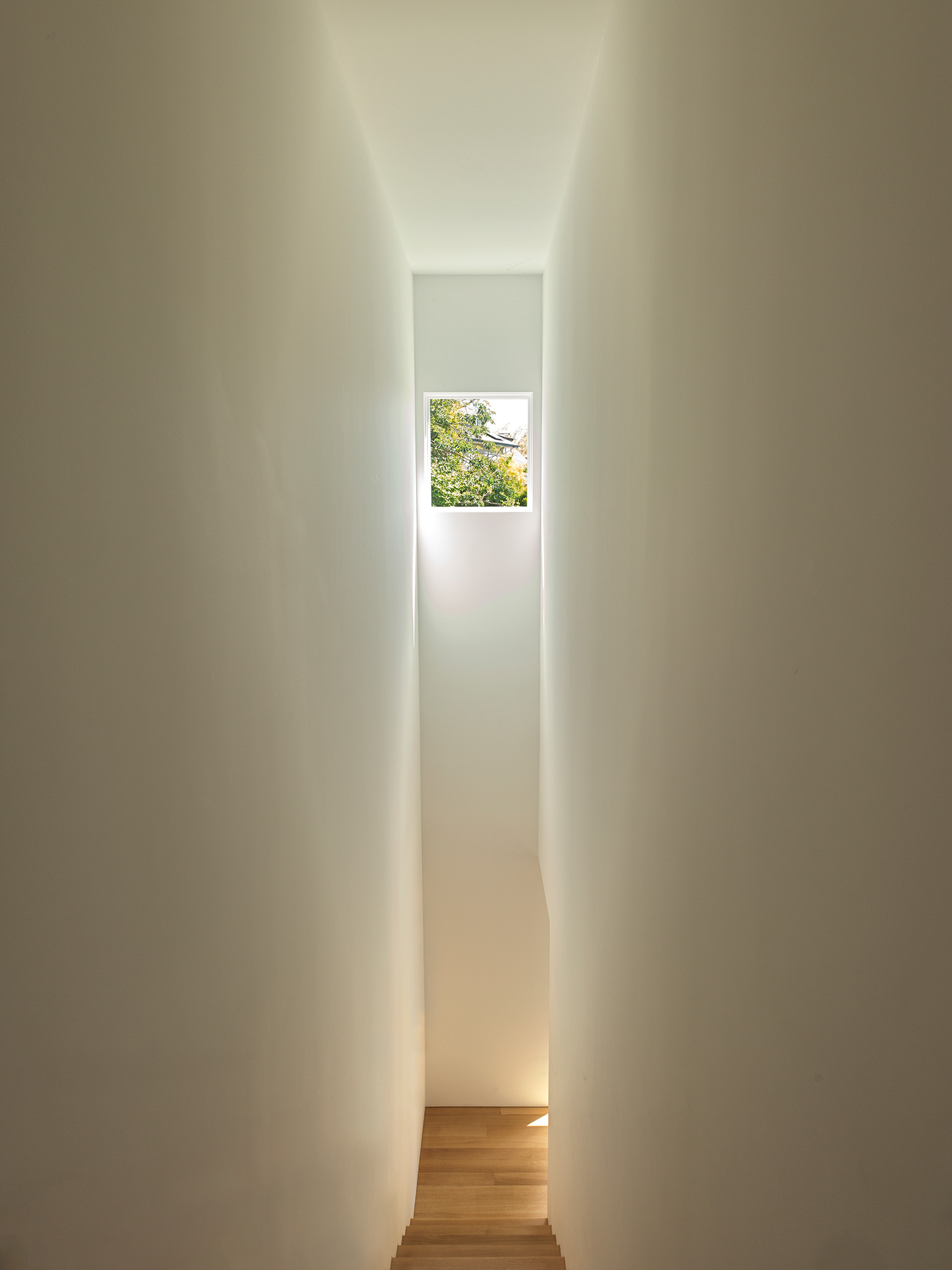 A narrow stairwell leads up to the principal bedroom suite