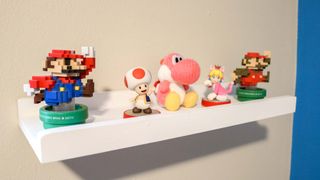 Mario-themed Amiibos displayed on a floating shelf