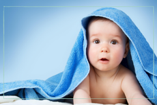 baby with blue towel on head