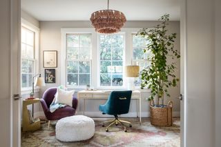 A home office with a fabric pendant light and carpets