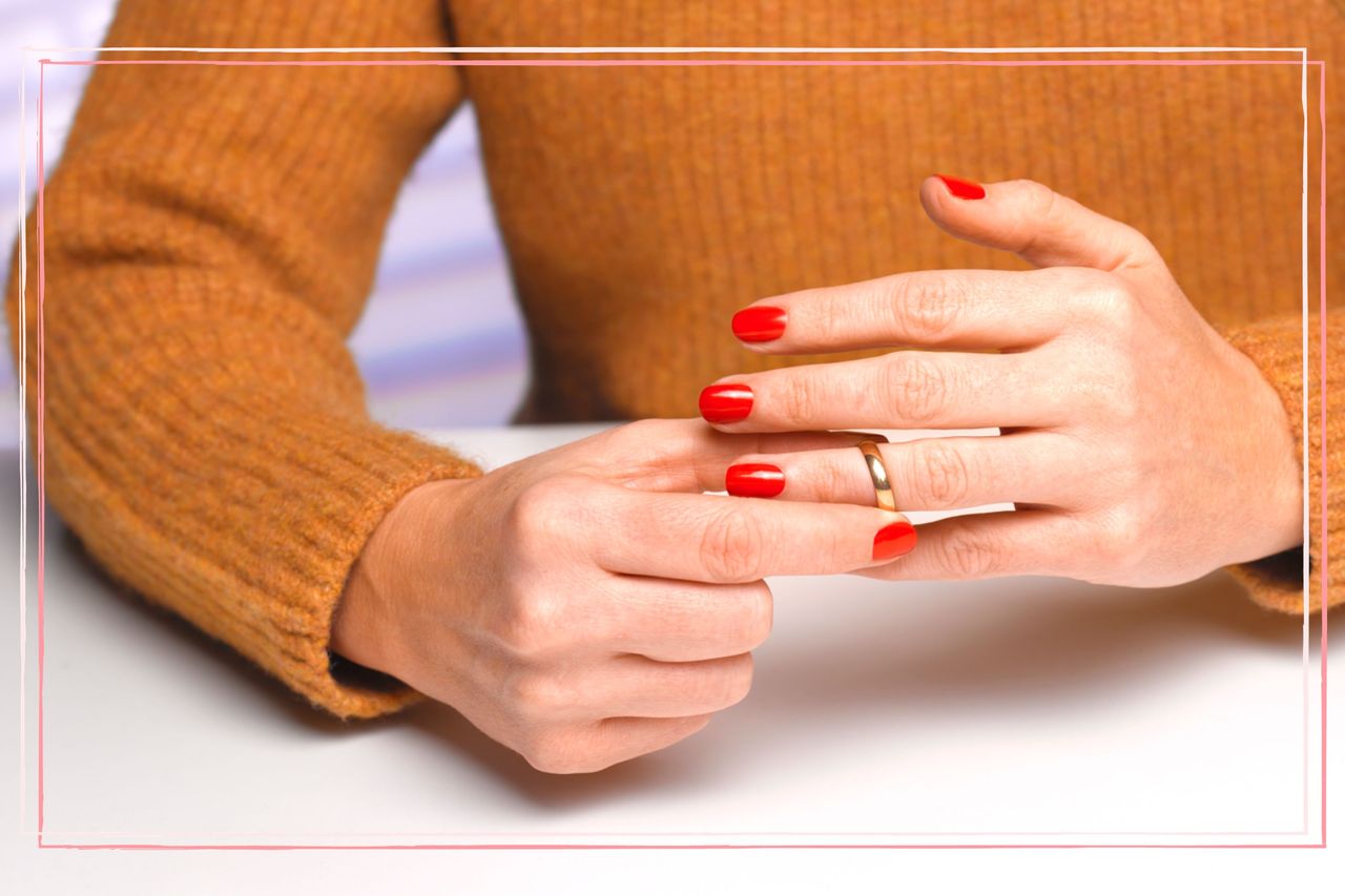 A close up of a woman taking off her wedding ring