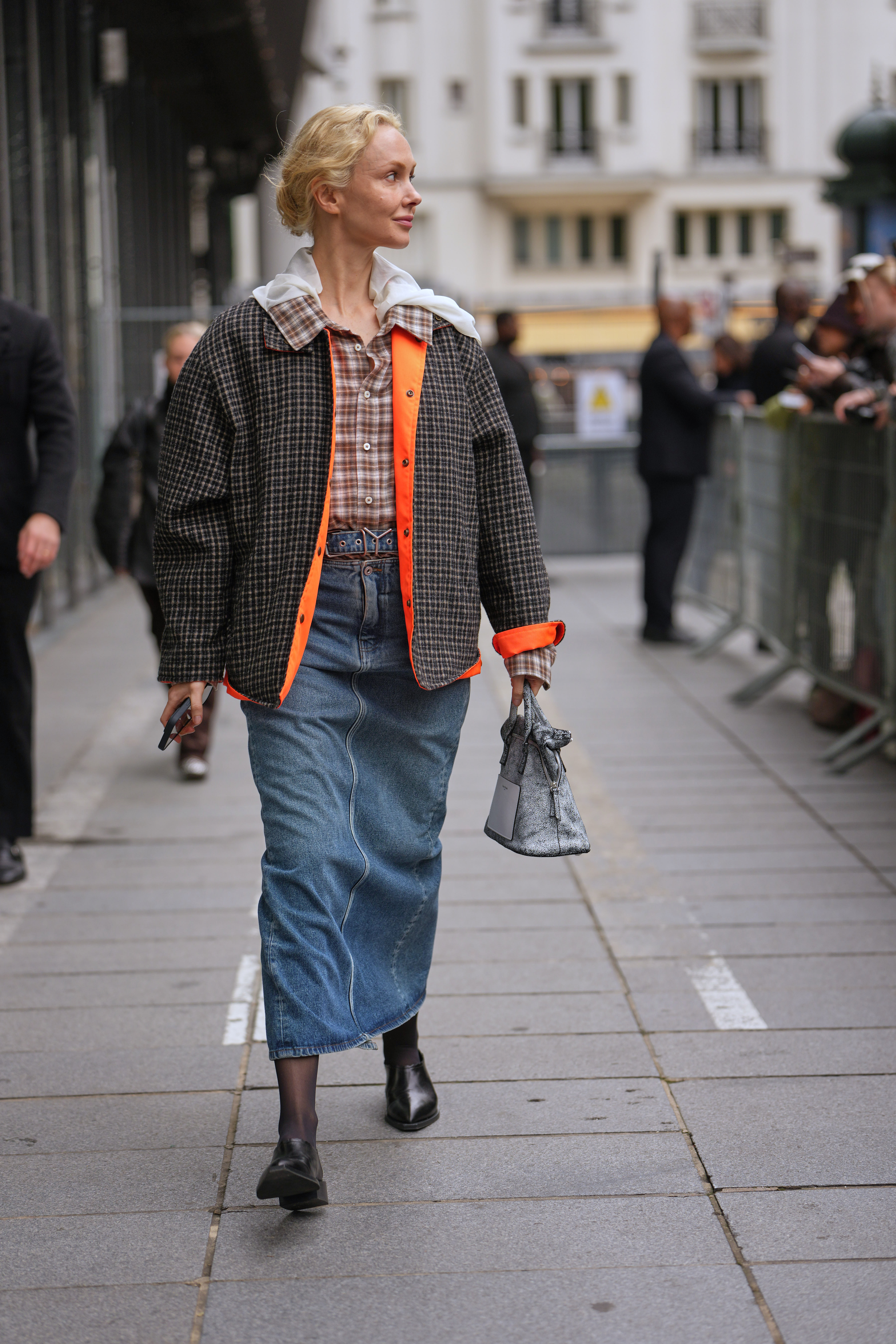 woman wearing button-down shirt, a jacket, a denim skirt, and shoes